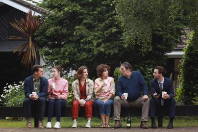 The cast of The Dry series 2 sitting in a garden 